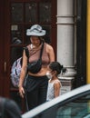 Vertical of a mother smiling and looking at her daughter in Chinatown street in Manhattan, New York