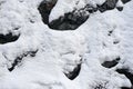 Vertical mountain slope with rocks covered with fresh snow - background texture. Royalty Free Stock Photo