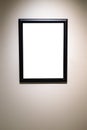 Vertical narrow black picture frame on gray wall