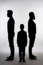 Shadows of three generations of men on white background