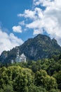 Vertical of the Neuschwanstein castle on green mountains in Fussen, Germany.