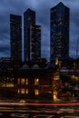 Vertical night view of Deansgate Square with four skyscraper towers under the cloudy sky Royalty Free Stock Photo