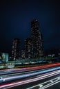 Vertical night view of Deansgate Square with its four towers, and blurred lights in long exposure