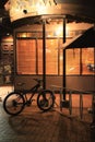 Vertical night view of the exterior of a shop, a parked bicycle, in Queenstown street in New Zealand