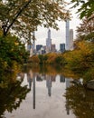 Vertical of NYC skyscrapers skyline and reflection through the autumn foliage of the Central park Royalty Free Stock Photo