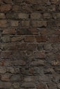 Vertical old brick brown wall texture. Grunge stone house for background close up Royalty Free Stock Photo
