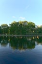 A vertical orientation of reflections of trees and clouds on lake water, La Fontaine Park, Montreal, QC, Canada Royalty Free Stock Photo