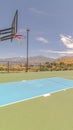 Vertical Outdoor basketball court and nets on sunny day