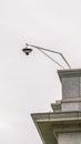 Vertical Outdoor cctv security camera installed at the corner of the roof of a building Royalty Free Stock Photo