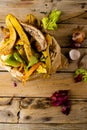 Vertical overhead of organic fruit and vegetable waste spilling from full kitchen composting bin Royalty Free Stock Photo