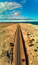 Vertical panorama view of the road between Flag Beach and Parque Naturale sand dunes