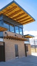 Vertical Park building with flat roof and brick wall under blue sky and bright sun