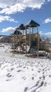 Vertical Park playground amid footprints on sunlit snow covering the ground in winter Royalty Free Stock Photo