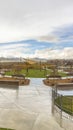 Vertical Park with view of vast cloudy sky over snow peaked mountain and homes