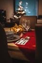 Vertical partial view of a simple decorated Christmas dinner table Royalty Free Stock Photo