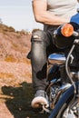 Vertical partial view of young biker riding a custom motorcycle