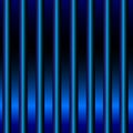 Vertical pattern featuring evenly spaced blue pipes against a dark background. Royalty Free Stock Photo