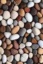 vertical pebbles texture background, closeup smooth stones in natural colors