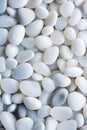 vertical pebbles texture background, closeup white smooth stones