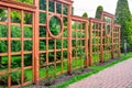 Vertical pergola made of wood in a rose garden with a stone tile walkway. Royalty Free Stock Photo