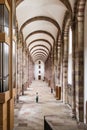 A vertical perspective view of an aisle with a high vaulted ceiling in Speyer cathedral in Germany