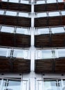 Vertical perspective view of angled modern glass apartment balconies on a blue steel building Royalty Free Stock Photo