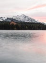 Vertical photo of beautiful lake in autumn scenery with amazing snowy mountains on background. Strbske pleso in High Tatras in Royalty Free Stock Photo