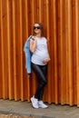 Vertical photo of a beautiful thirty-year-old pregnant woman