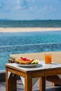 Vertical photo of breakfast with swimming pool background Royalty Free Stock Photo