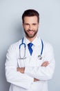 Vertical photo of cheerful smiling doc standing with crossed han Royalty Free Stock Photo