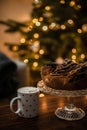 Vertical photo of chocolate wreath in front of a Christmas tree