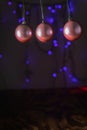 vertical photo of christmas balls on pendulum with lights background Royalty Free Stock Photo