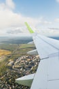 Vertical photo of civil passenger aircraft wing taken from inside the plane. Green wingtip devices. Royalty Free Stock Photo