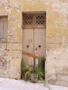 Vertical photo of closed shabby front door to abandoned house or production warehouse