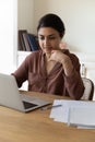 Vertical photo confident Indian woman using laptop, sitting at desk