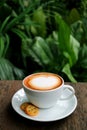 Vertical Photo of a Cup of Hot Cappuccino Coffee with Cookies Served on Wooden Table Royalty Free Stock Photo