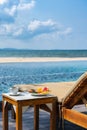 Vertical photo of delicious breakfast on the peaceful beach Royalty Free Stock Photo