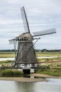 Vertical photo of the polder windmill `Het Noord` on wadden sea island Texel in the Netherlands with a blue sky and some clouds Royalty Free Stock Photo