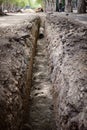 Vertical photo excavated trench on the road in the city for the reconstruction of the water supply Royalty Free Stock Photo