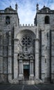 Facade of the imposing and somber Porto Cathedral, contrasting with blue sky. The famous Se do Porto in Portugal.
