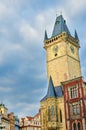 Vertical photo of famous Old Town Hall in Czech capital Prague. Photographed during sunrise golden hour with dark clouds above. Royalty Free Stock Photo