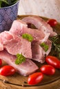 Several pork filets on chopping board with herbs, spice and tomatoes Royalty Free Stock Photo