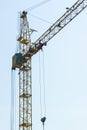Vertical photograph of a fragment of a construction crane against a clear sky