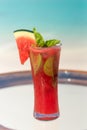 Vertical photo of fresh watermelon juice with mint on the glass table ocean background at the beach Royalty Free Stock Photo