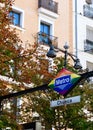 Vertical photo of gay symbolic in lgbt friendly district in Madrid, Spain. Chueca metro station signboard with autumnal background Royalty Free Stock Photo