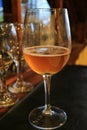 Vertical photo of a glass of amber color chilled craft beer on the dining table