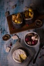 Top view on Melted camembert cheese on wooden board with onions and fried potato stripps Royalty Free Stock Photo