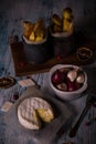 Melted camembert cheese on wooden board with onions and fried potato stripps Royalty Free Stock Photo