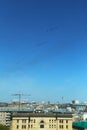 Vertical photo of a group of eight russian military fighter jet planes flying in two rows formation high in blue sky at Vicotry