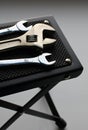 Vertical photo of hex wrenches and adjustable spanner on textured rubber surface of table support coaster Royalty Free Stock Photo